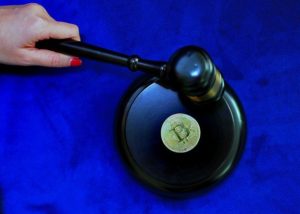 bitcoin coin with a Judge's hammer